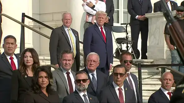 Trump Uses Memorial Of Fallen Soldiers As A Photo-Op With Standard Trumpian Thumbs Up And Cheshire Smile